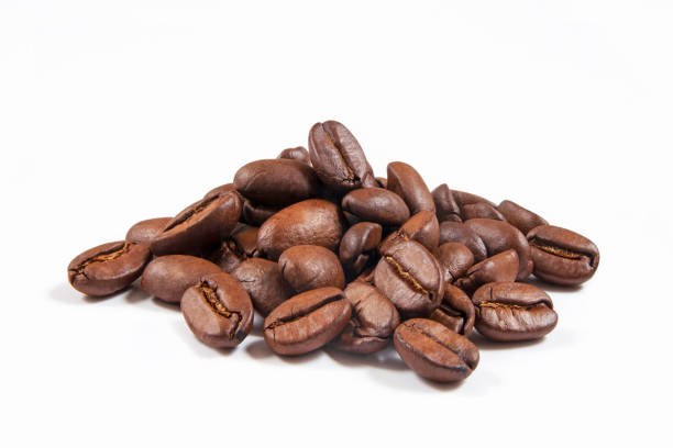 Heap of roasted coffee beans isolated on white background