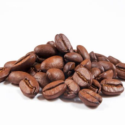 Heap of roasted coffee beans isolated on white background